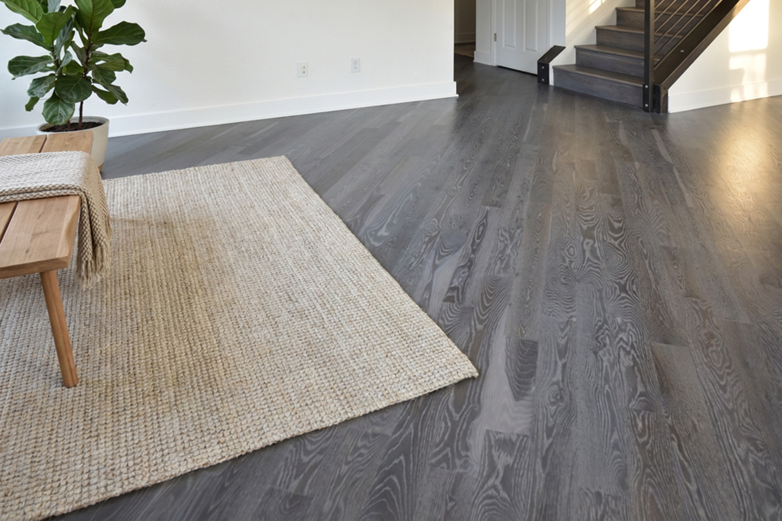 Gray-brown hardwood floor with visible grain variation after Rubio Monocoat Fumed and White 5% oil