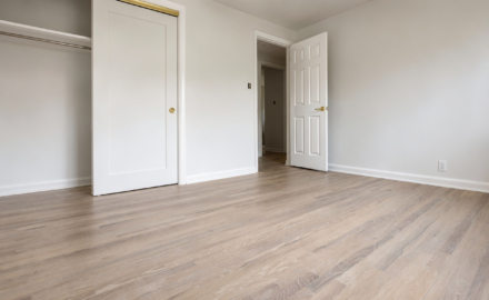 Light-toned red oak floor in a finished bedroom