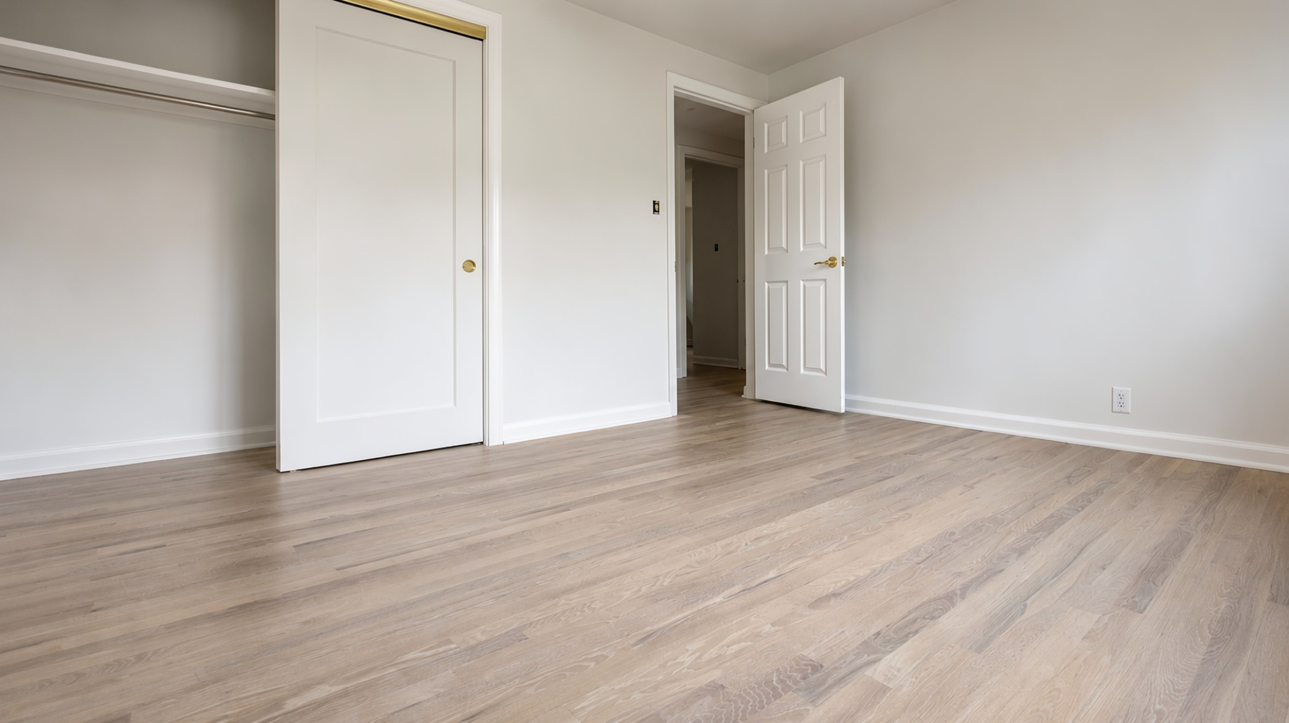 Light-toned red oak floor in a finished bedroom
