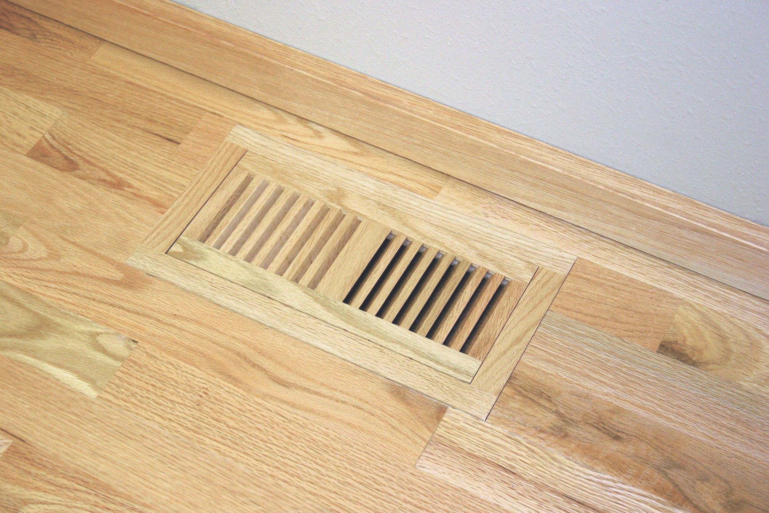 Flush wood vent installed in a hardwood floor