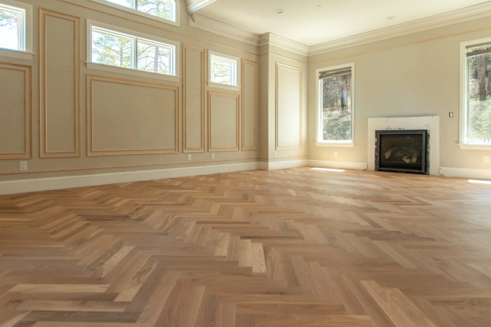 Wide room with a water-popped white oak herringbone floor finished in Smoke 5%