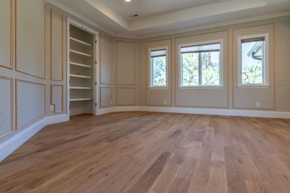 Straight-plank white oak floor in a room with built-in shelving